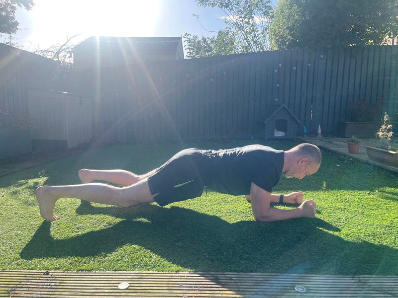 Stephen in a forearm plank, side view