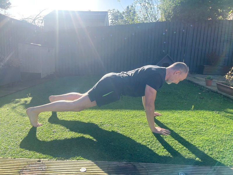 Stephen at the top of a press-up, side view, head in line with his spine