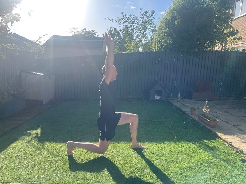 Stephen at the bottom of a split squat, side view, back knee just short of the ground