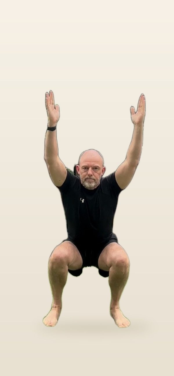 Stephen in a deep squat with arms overhead, front view, torso upright